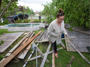 Dana Miller surveys damage in her backyard as a reported tornado touched down in the Orléans suburb of Ottawa on Sunday evening