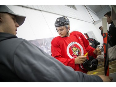 Erik Brannstrom fixes up a glove before hitting the ice.