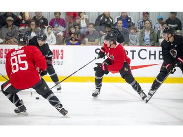 Alex Formenton tries to get the puck away from Jonathan Tychonick during the 3-on-3 tournament.