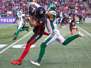 Seth Coate of Ottawa makes a catch with Nick Marshall hanging off him in the first half as the Ottawa Redblacks take on the Saskatchewan Roughriders in CFL action at TD Place in Ottawa.
