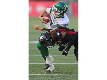 Saskatchewan QB Cody Fajardo tries to avoid a tackle in the first half as the Ottawa Redblacks take on the Saskatchewan Roughriders in CFL action at TD Place in Ottawa. Photo by Wayne Cuddington / Postmedia