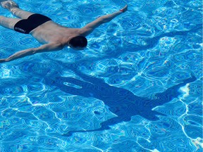 A man swims in a pool on a hot summer day. Like today. Today is a hot summer day. Today is finally a hot summer day.