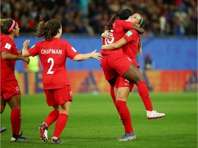 Nichelle Prince leaps into the arms of a teammate after scoring Canada's second goal in Saturday's World Cup group against New Zealand.