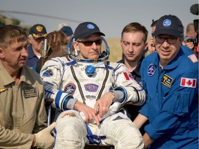 Expedition 59 Canadian Space Agency astronaut David Saint-Jacques is carried to a medical tent shortly after he, NASA astronaut Anne McClain, and Roscosmos cosmonaut Oleg Kononenko landed in their Soyuz MS-11 spacecraft near the town of Zhezkazgan, Kazakhstan on Tuesday, June 25,