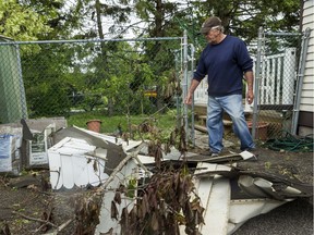 Maurice Tremblay looks at his shed damaged by a tornado that touched down in Orléans on Sunday evening.