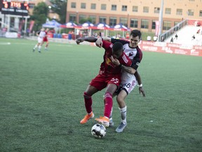 Ottawa Fury FC defender Dakota Barnathan gets a bit rough with New York Red Bulls II forward Sebastian Elney during Friday night’s game. (New York Red Bulls II/USL Championship)