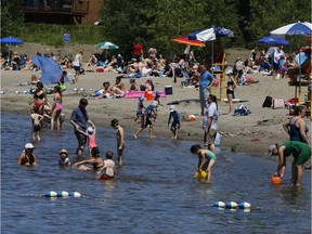 People enjoy the nice weather near Britannia Beach in Ottawa.