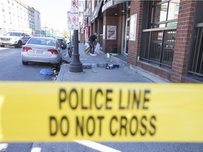 Investigators collect evidence at a homicide occurred along Dalhousie Street in the ByWard Market last week.  Photo by Wayne Cuddington/ Postmedia