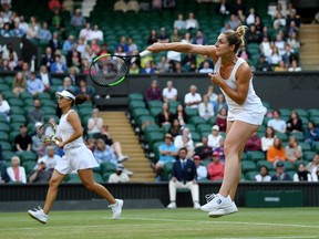 Gabriela Dabrowski of Ottawa, playing partner of Yifan Xu of China plays a forehand in their Ladies' Doubles final against Su-Wei Hsieh of Taiwan, playing partner of Barbora Strycova of The Czech Republic during Day thirteen of The Championships - Wimbledon 2019 at All England Lawn Tennis and Croquet Club on Sunday in London, England.