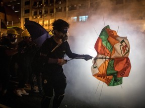 HONG KONG, HONG KONG - JULY 21: Protesters clash with police amid tear gas after taking part in an anti-extradition bill march on July 21, 2019 in Hong Kong, China. Pro-democracy protesters have continued weekly rallies on the streets of Hong Kong against a controversial extradition bill since June 9, as the city plunged into crisis after waves of demonstrations and several violent clashes. Hong Kong's Chief Executive Carrie Lam apologized for introducing the bill and recently declared it "dead", however protesters have continued to draw large crowds with demands for Lam's resignation and completely withdraw the bill. (Photo by Chris McGrath/Getty Images)