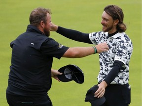 Open Champion Shane Lowry of Ireland hugs Tommy Fleetwood of England on the 18th green during the final round of the 148th Open Championship held on the Dunluce Links at Royal Portrush Golf Club on July 21, 2019 in Portrush, United Kingdom.