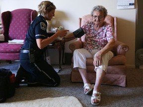 Stephanie Rose, a community care paramedic,  looks after Maria Makkos, 82, during their initial consultation at Maria's home in Arnrprior.