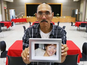 Tommy Papatsie holds a picture of his sister, Mary Papatsie, prior to a gathering to remember his missing sister, July 20, 2019.