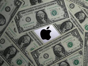 U.S. dollar banknotes and the Apple logo are seen in this photo illustration.