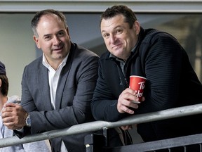 General manager Pierre Dorion (L) and new head coach DJ Smith watch their players at the Ottawa Senators development camp at the Bell Sensplex on June 27, 2019.