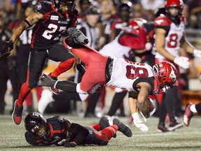 Calgary Stampeders running back Terry Williams is tackled by Ottawa Redblacks defensive back Corey Tindal during second half CFL action in Ottawa on Thursday, July 25, 2019. THE CANADIAN PRESS/Sean Kilpatrick