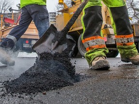 City of Ottawa road crews fill potholes.