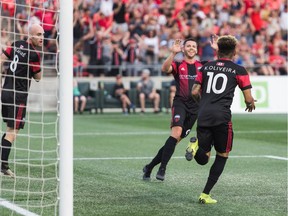 Ottawa Fury captain Carl Haworth (facing) and teammate Kevin Oliveira celebrate after one of their team's goals in a 4-0 victory against Swope Park Rangers in a United Soccer League Championship match at TD Place stadium in Ottawa, ON. Canada on July 20, 2019.  PHOTO: Steve Kingsman/Freestyle Photography for Ottawa Fury FC