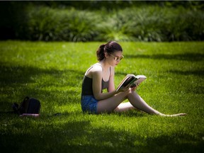 A woman enjoys a book in Confederation Park.