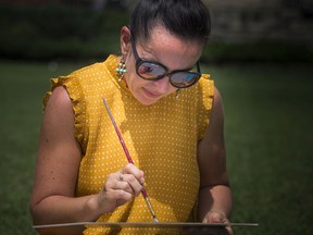 Art for Mental Health hosted Paint Therapy Ottawa, an event for people to come together to paint in support of mental health. The event took place Sunday, July 28, 2019, on Parliament Hill. Valeria Triboi worked on her piece of art Sunday afternoon.   Ashley Fraser/Postmedia