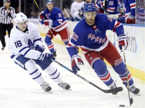 Kevin Shattenkirk of the New York Rangers skates with the puck against Mitchell Marner of the Toronto Maple Leafs in December 2017.