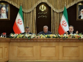 A handout picture provided by the Iranian presidency on July 7, 2019 shows (left to right) Iran's Atomic Energy Organisation spokesman Behrouz Kamalvandi, government spokesman Ali Rabiei, and Deputy Foreign Minister Abbas Araghchi giving a joint press conference at the presidential headquarters in the capital Tehran on July 7, 2019. (AFP/Getty Images)