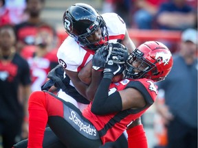 Calgary's Tre Roberson intercepts a pass by the Redblacks in a game on June 15. It was one of 16 turnovers in six games this season by Ottawa.