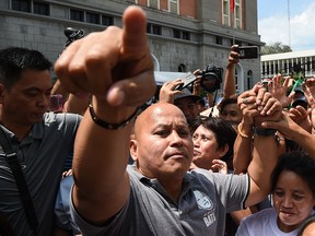 Philippines' former national police chief, Ronald dela Rosa (C) is greeted by supporters after filing his certificate of candidacy (CoC) for senator at the commission on elections office in Manila on Oct. 12, 2018, for the May 2018 mid-term election.