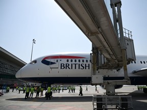 Pakistani airport ground staff gather around the British Airways aircraft after landing at the Islamabad International Airport, on the outskirts of Islamabad on June 3, 2019. (AAMIR QURESHI/AFP/Getty Images)