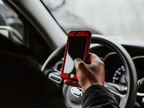 FILE: Using a phone will driving.
