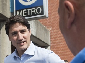 Prime Minister Justin Trudeau greets commuters outside St. Michel metro station in Montreal, Thursday, July 4, 2019.