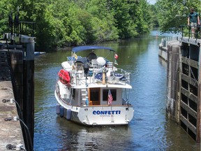 A large yacht motors through the swing bridge at Hog's Back as it heads into the locks and then up the Rideau Canal.