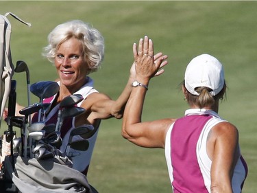 Lee Zomer, left, and partner Marie Lusson take part in the Ottawa Sun Scramble at the Marshes Golf Club on Saturday.