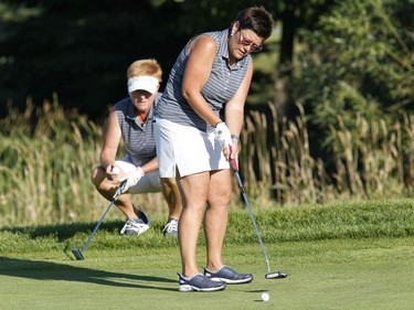 Johanne Verrier, left, and partner Micheline Montreuil take part in the Ottawa Sun Scramble at the Marshes Golf Club on Saturday.