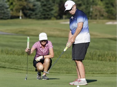 Marcy Cooper, left, and partner Ann Baldwin take part in the Ottawa Sun Scramble at the Marshes Golf Club on Saturday.