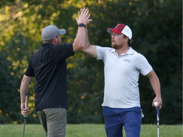 Craig Briscoe, left, and his partner Jacob Fulton celebrate after winning the Mens C division at the Ottawa Sun Scramble at the Marshes Golf Club on Saturday.