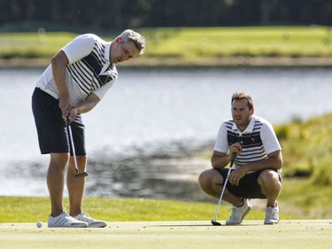 Mitch Dale, left, and Andy Rajhathy take part in the Ottawa Sun Scramble at the Eagle Creek Golf Club on Sunday.