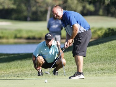 Allen McGee, left, and Kyle Koski take part in the Ottawa Sun Scramble at the Eagle Creek Golf Club on Sunday.