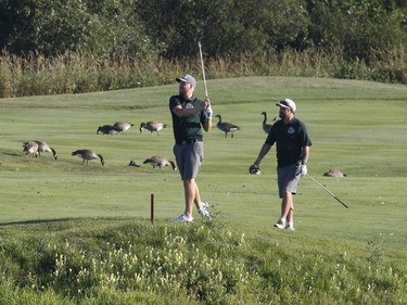Adrian Moyes, left, and Aaron Don take part in the Ottawa Sun Scramble at the Eagle Creek Golf Club on Sunday.