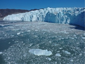 In this aerial view, ice that has broken off from the Eqip Sermia Glacier, also called the Eqi Glacier, drifts away from the glacier's 200-metre-tall face during unseasonably warm weather on Aug. 2, 2019 at Eqip Sermia, Greenland. Eqip Sermia is located approximately 350 km north of the Arctic Circle.