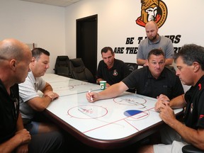 The Ottawa Senators new coaching staff (from left) Davis Payne, Bob Jones, Pierre Groulx, Mike King, D.J. Smith and Jack Capuano, talk things over at team meetings last week.