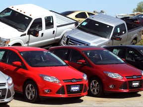 A row of Ford Focus (bottom) are displayed next to Ford F-Series pickups at Koons Ford in Silver Spring, Maryland April 3, 2012. REUTERS/Gary Cameron