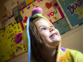 Hillary McKibbin shows off notes from classmates on her bedroom wall.