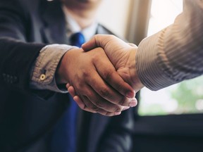 Two business men shaking hands during a meeting to sign agreement and become a business partner, enterprises, companies, confident, success dealing, contract between their firms. Getty Images/iStockphoto