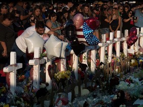 People pay their respects at the makeshift memorial for victims of the shooting that left a total of 22 people dead at the Cielo Vista Mall Walmart in El Paso, Texas, on Aug. 6, 2019.