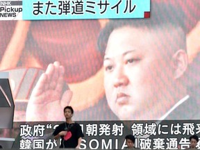 Footage of North Korea's leader Kim Jong Un is seen on a giant television screen in Tokyo on August 24, 2019, reporting on North Korea's missile launch earlier in the day. - North Korea on August 24 fired what appeared to be two short-range ballistic missiles into the sea after vowing to remain the biggest "threat" to the United States and branding Secretary of State Mike Pompeo as "toxin."