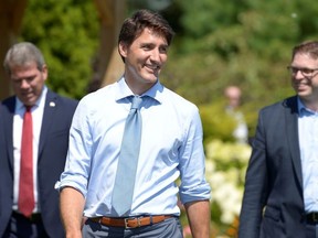 Canada's Prime Minister Justin Trudeau reacts as he walks to the podium to speak with reporters about a watchdog's report that he breached ethics rules by trying to influence a corporate legal case regarding SNC-Lavalin, in Niagara-on-the-Lake, Ontario, Canada, August 14, 2019.