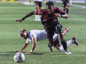Making his debut for Ottawa Fury FC, Hadji Barry tries to pull away from Mikey Lopez of Birmingham Legion FC in a United Soccer League Championship match at at TD Place Stadium in Ottawa, ON. Canada on August 2, 2019. The game ended in a 0-0 draw.