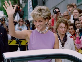 Diana, Princess of Wales, waves to the public as she leaves the Victor Chang Cardiac Research Institute in Sydney on Nov. 1, 1996.