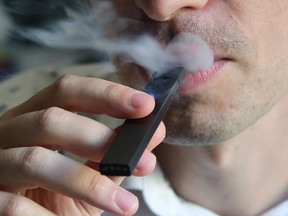 This file photo illustration taken on October 2, 2018, shows a man exhaling smoke from an electronic cigarette in Washington, D.C. (EVA HAMBACH/AFP/Getty Images)